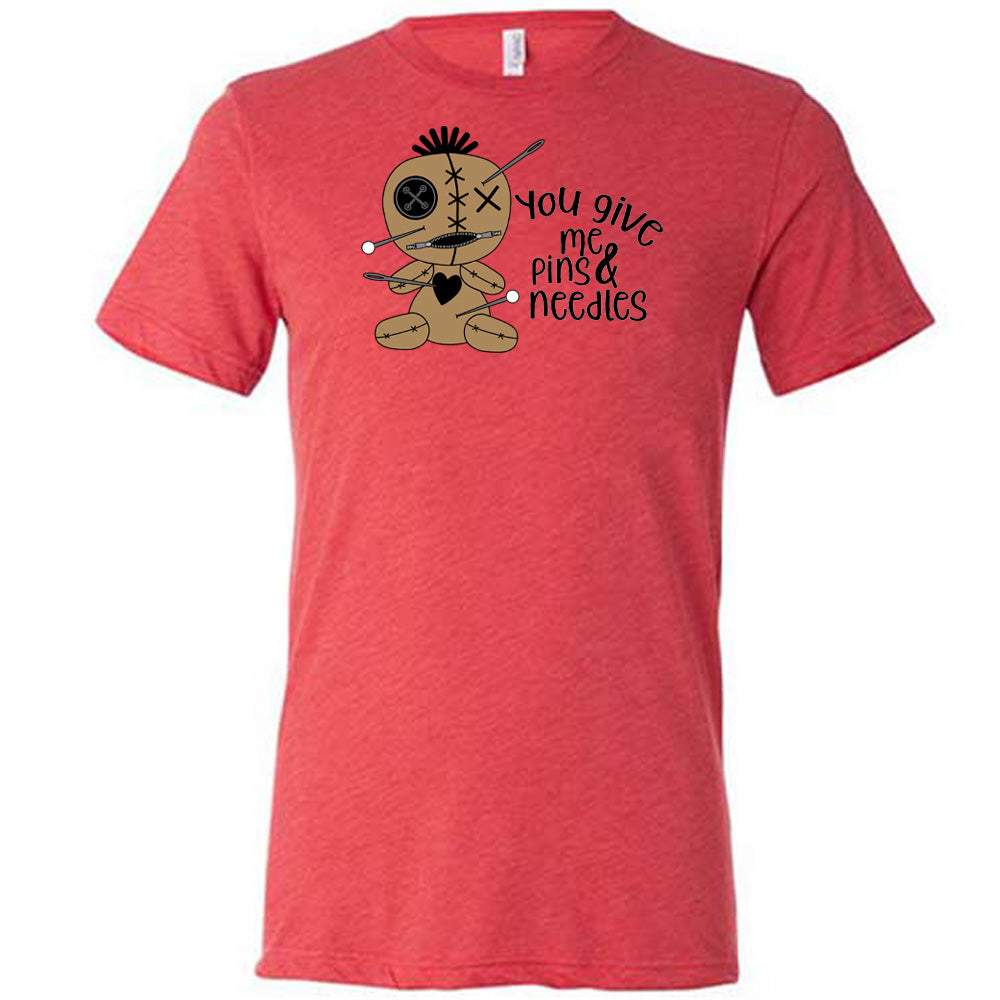 red shirt with a voodoo doll graphic and the quote "You Give Me Pins And Needles" on it