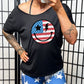 black slouchy tee with an american flag smiley face on it.