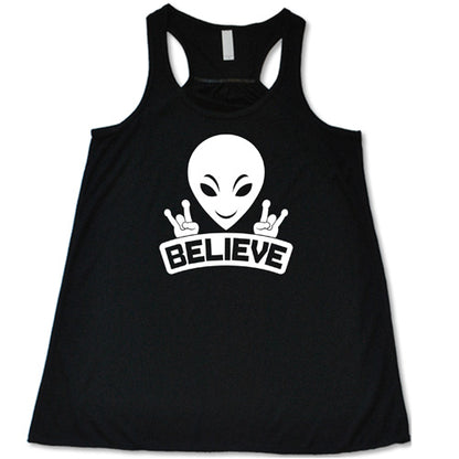 black racerback tank top that has an alien design on it that says "believe"