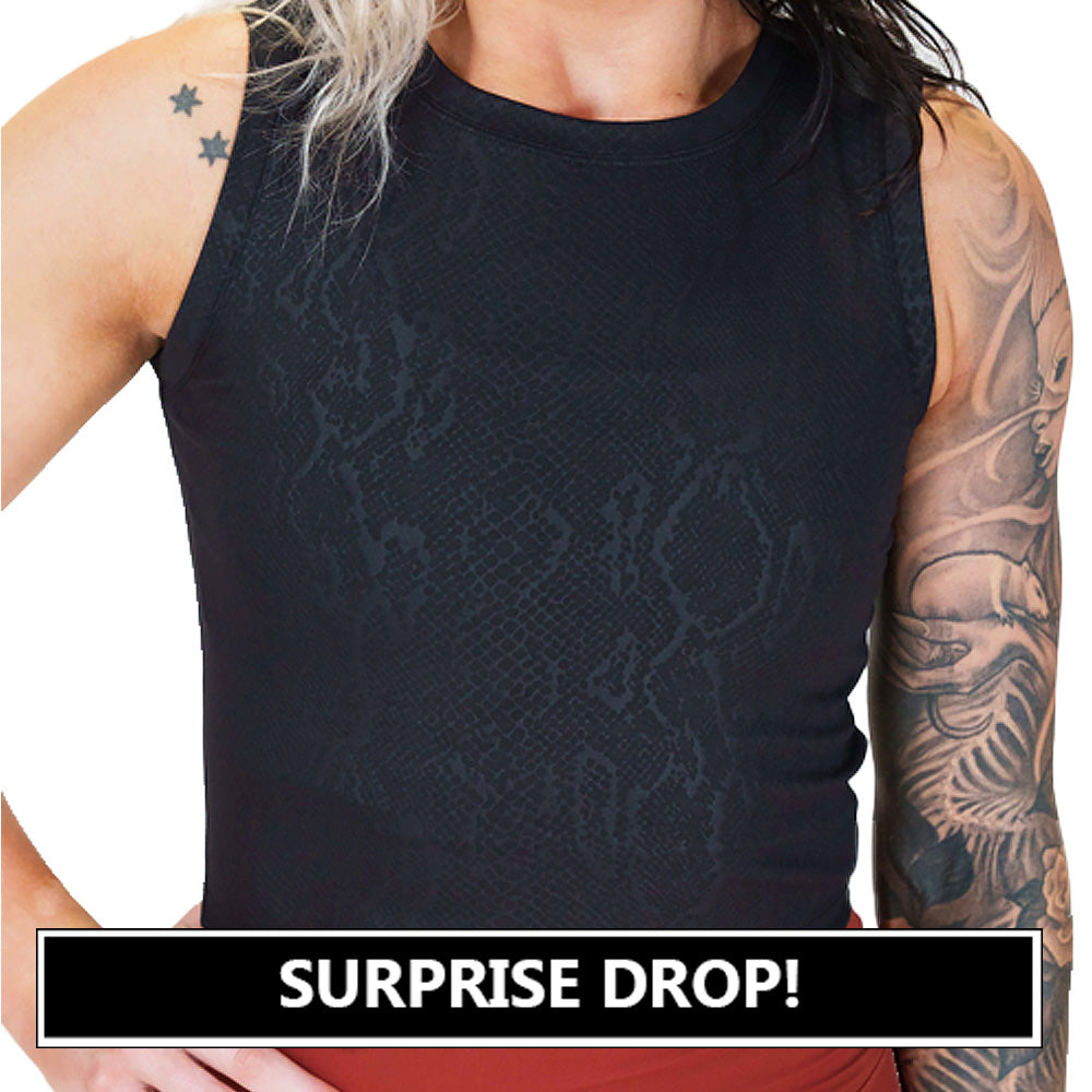 the front of the black snakeskin print crop top surprise drop