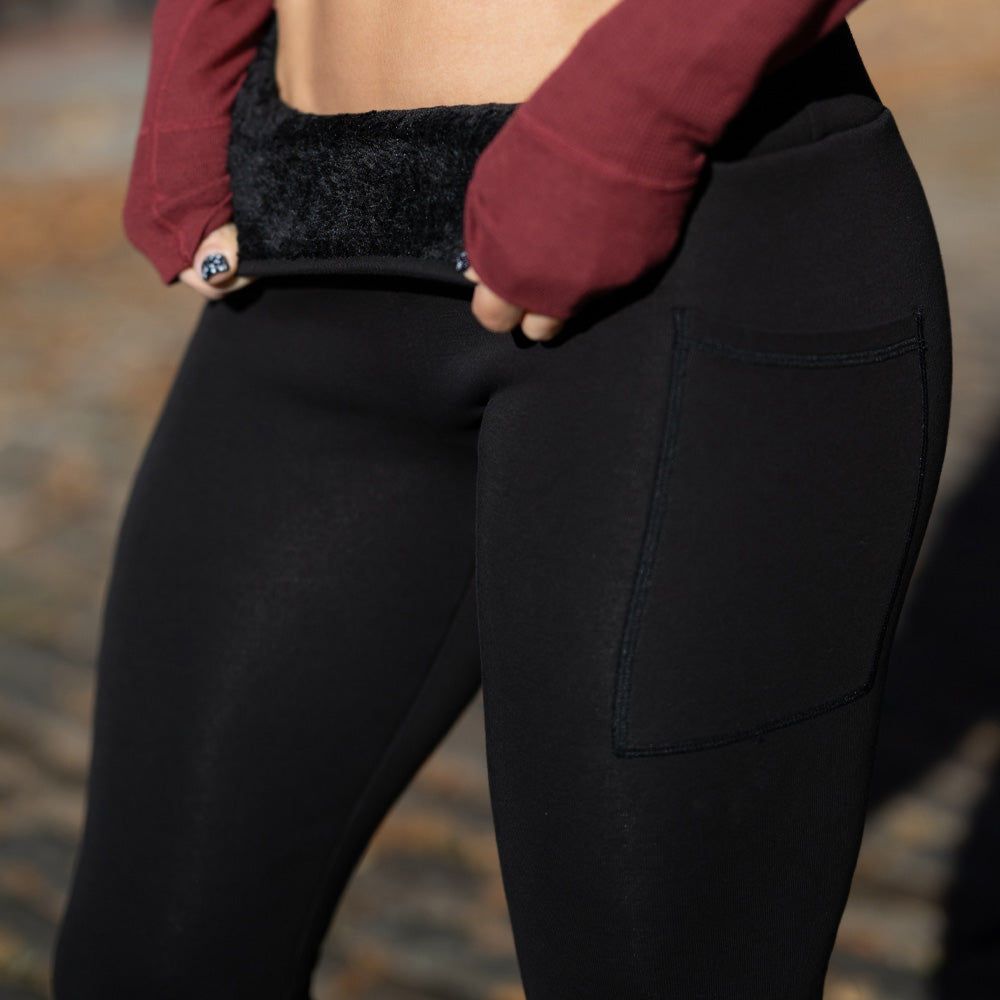 photo showing close up of black fleece lined inside material of black solid colored leggings