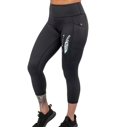 capri length black leggings with a graphic of a knife and text "killin it" on them 