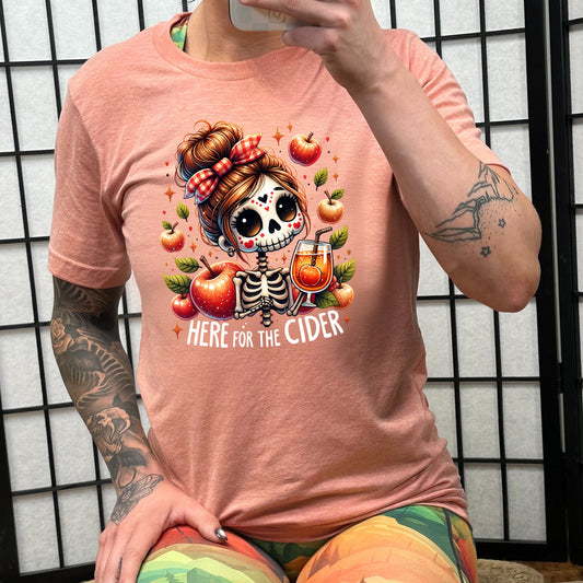 model wearing the peach "Here For The Cider" shirt