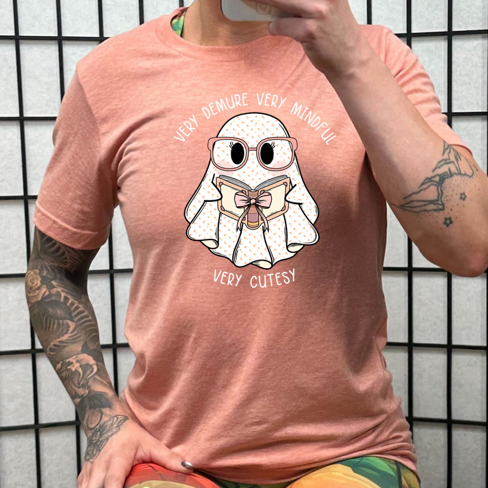 peach shirt with a ghost graphic and "very demure very mindful very cutesy" text on it