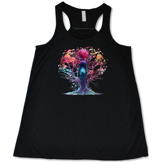 black shirt with a colorful enchanted tree graphic in the center