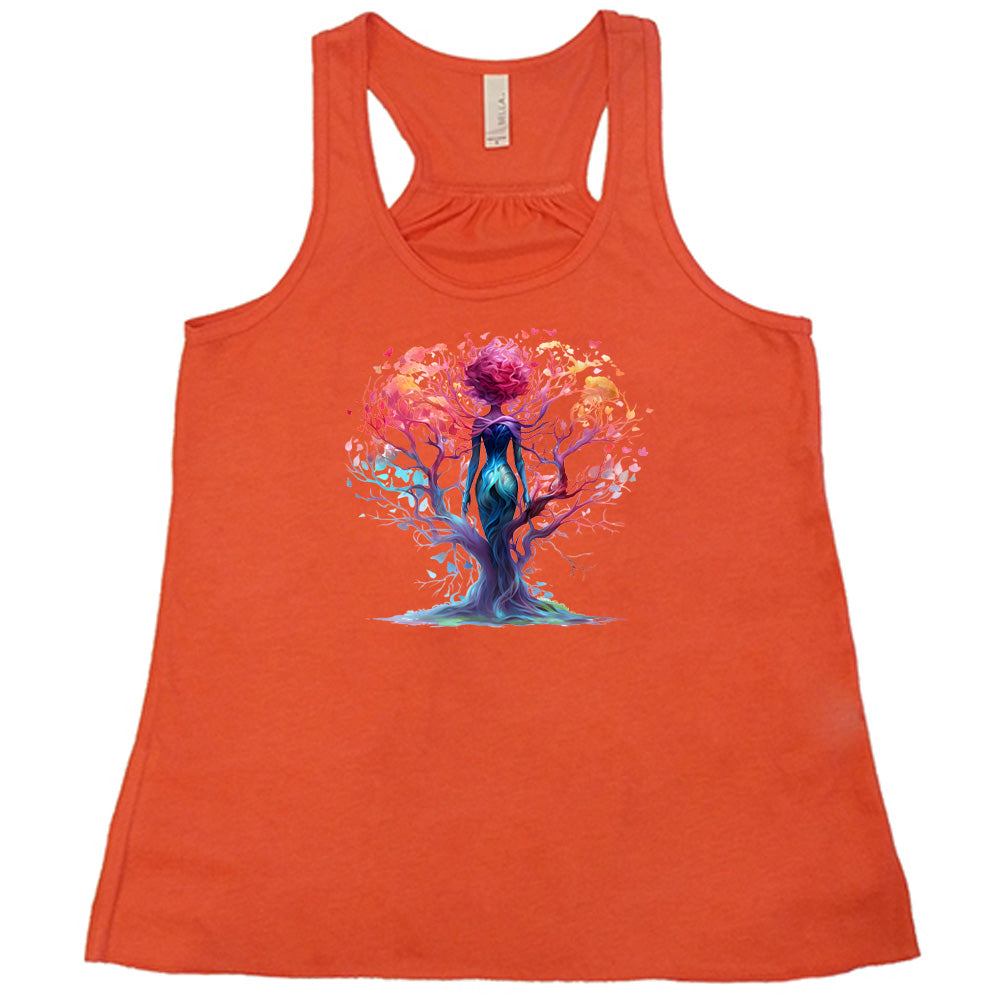 coral shirt with a colorful enchanted tree graphic in the center