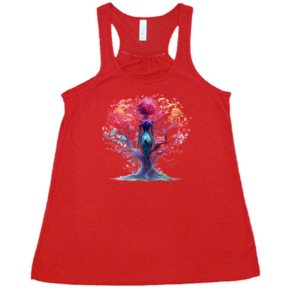 red shirt with a colorful enchanted tree graphic in the center