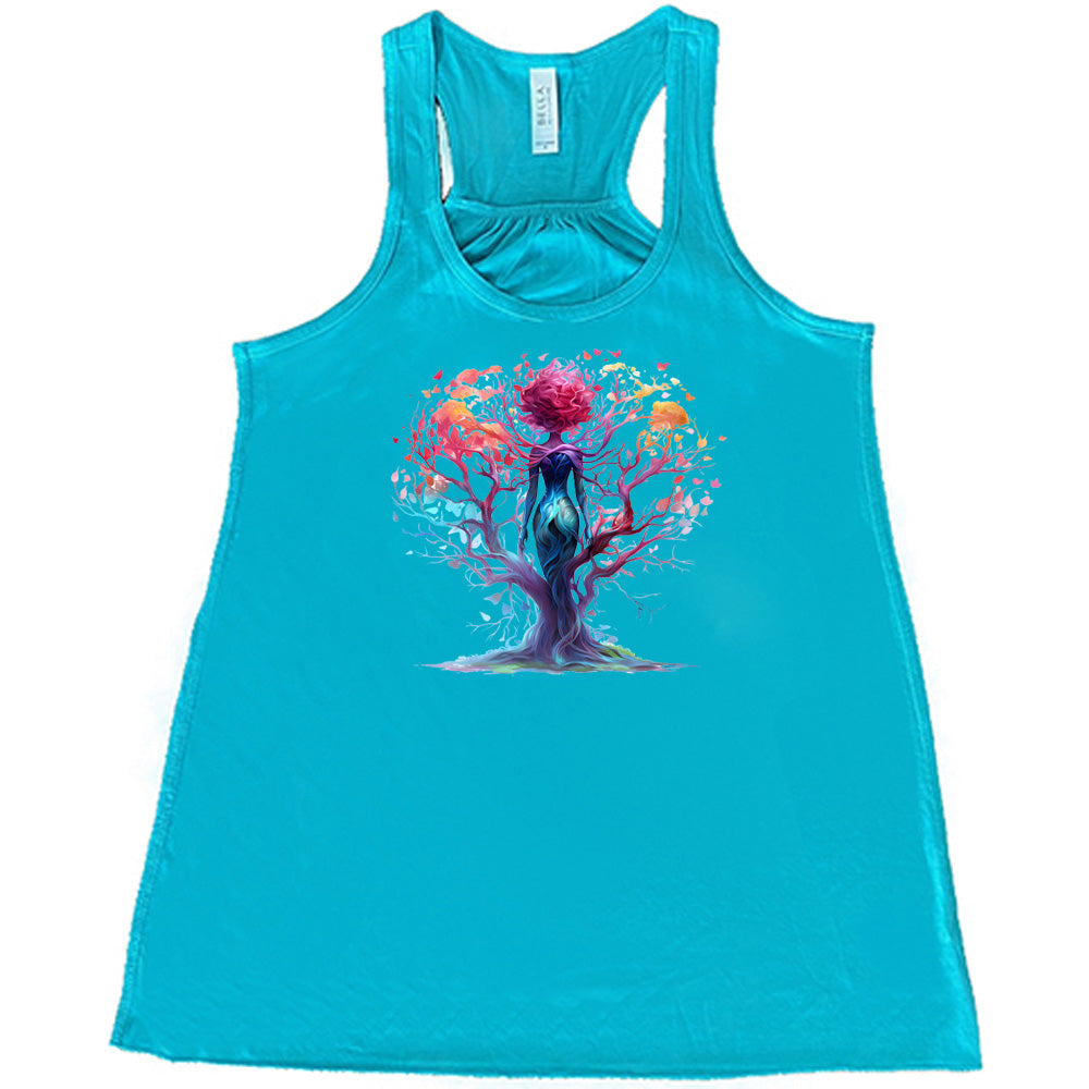 teal shirt with a colorful enchanted tree graphic in the center