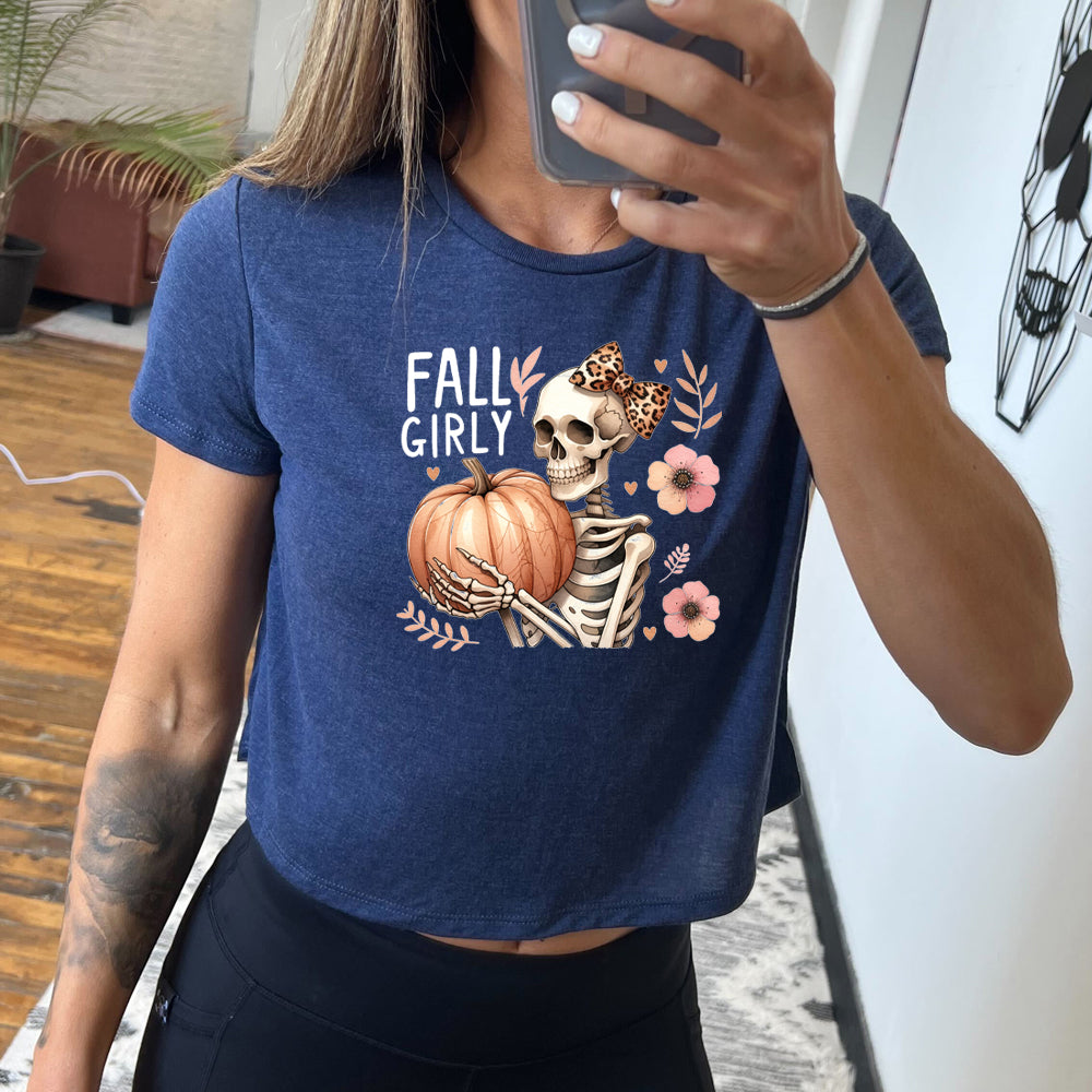 blue crop top with a skeleton and the quote "fall girly" on it