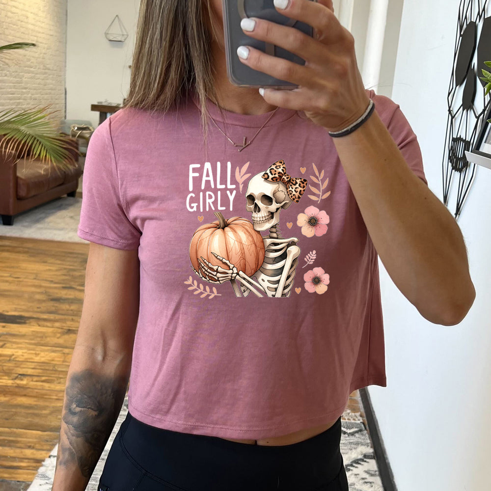 mauve crop top with a skeleton and the quote "fall girly" on it