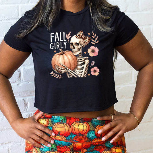 black crop top with a skeleton and the quote "fall girly" on it