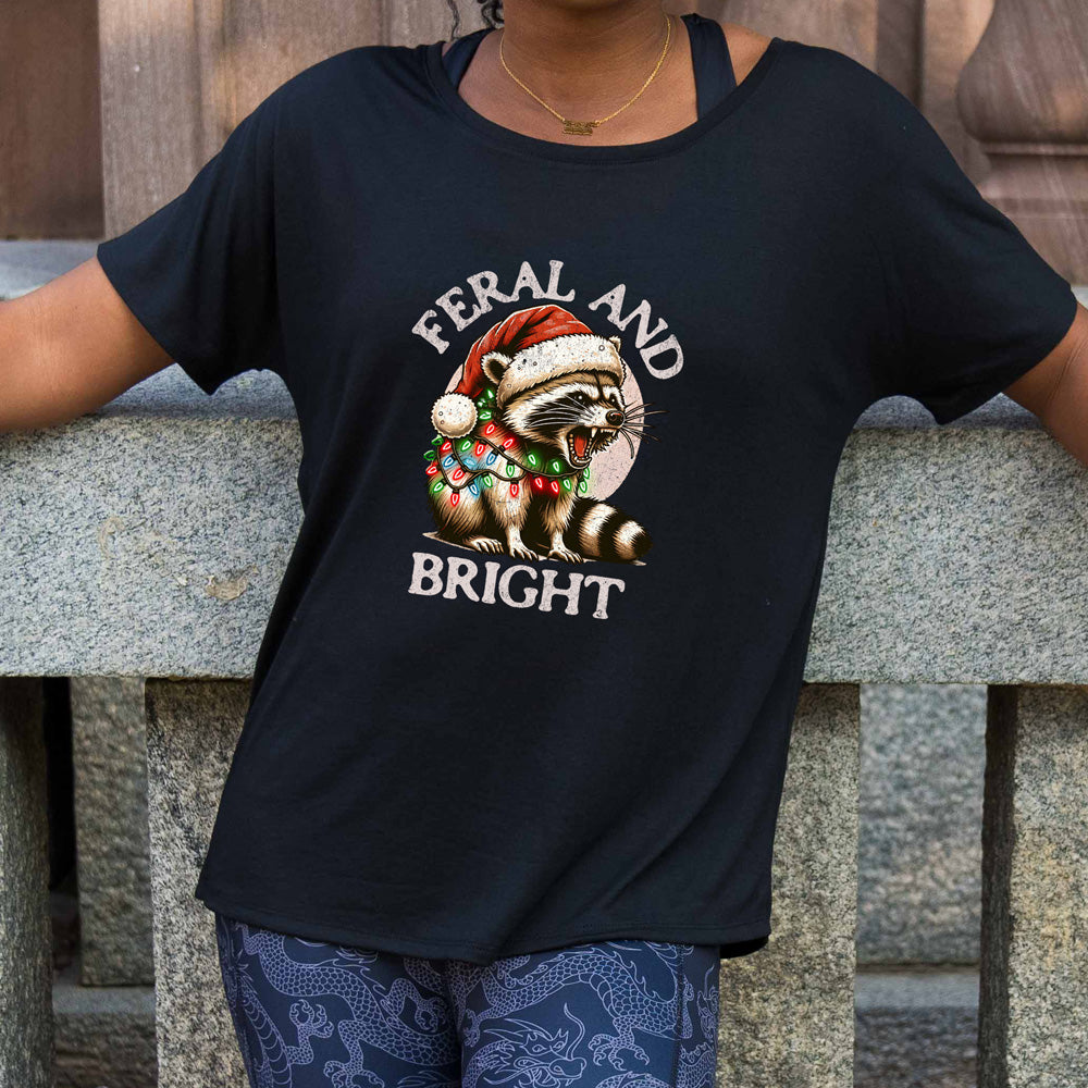 slouchy shirt with the text "Feral And Bright" with a raccoon graphic on it