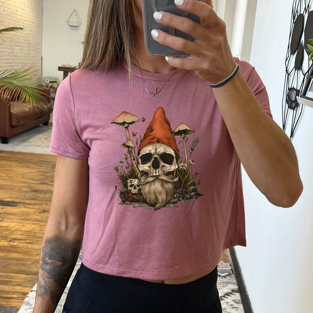 mauve cropped tee with a gnome skull graphic in the center