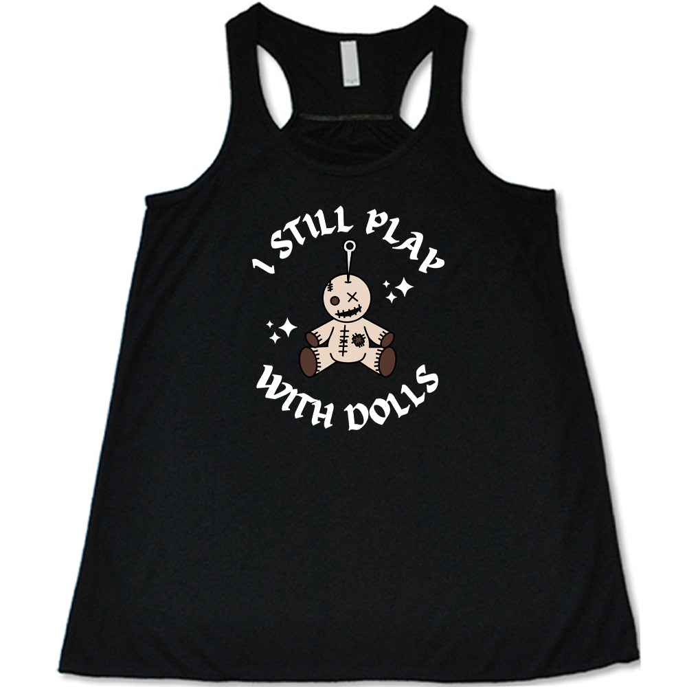 black shirt that has a voodoo doll graphic and the text "i still play with dolls" on it