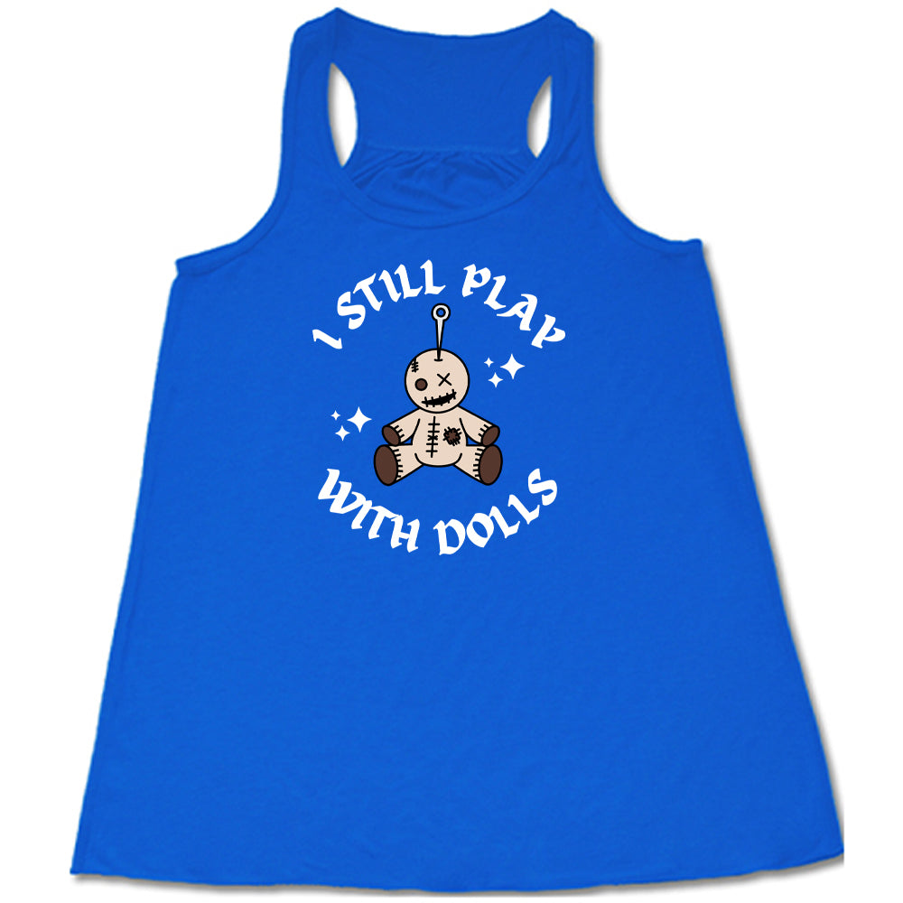 blue shirt that has a voodoo doll graphic and the text "i still play with dolls" on it