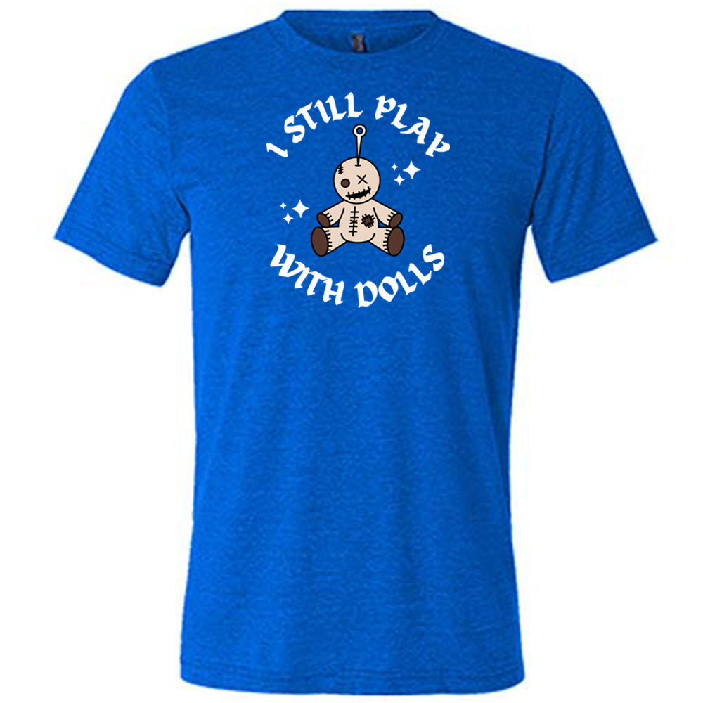 blue shirt that has a voodoo doll graphic and the text "i still play with dolls" on it