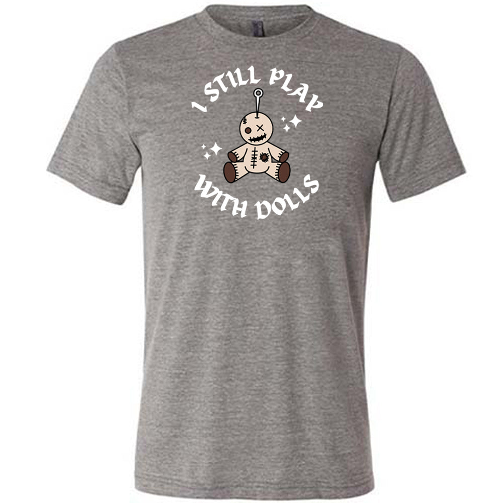 grey shirt that has a voodoo doll graphic and the text "i still play with dolls" on it