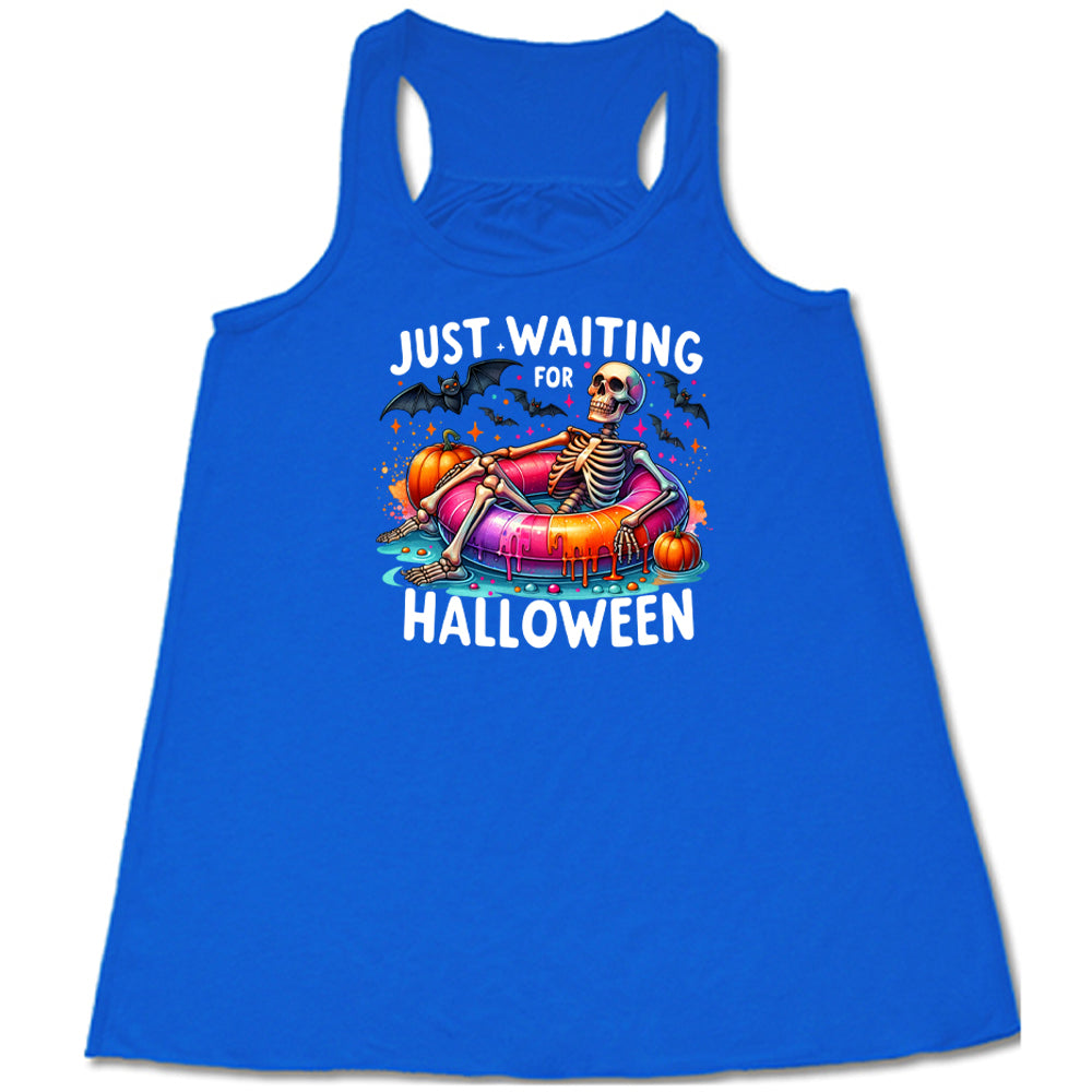 blue shirt with a colorful skeleton graphic in the center with the quote "Just Waiting For Halloween" on it