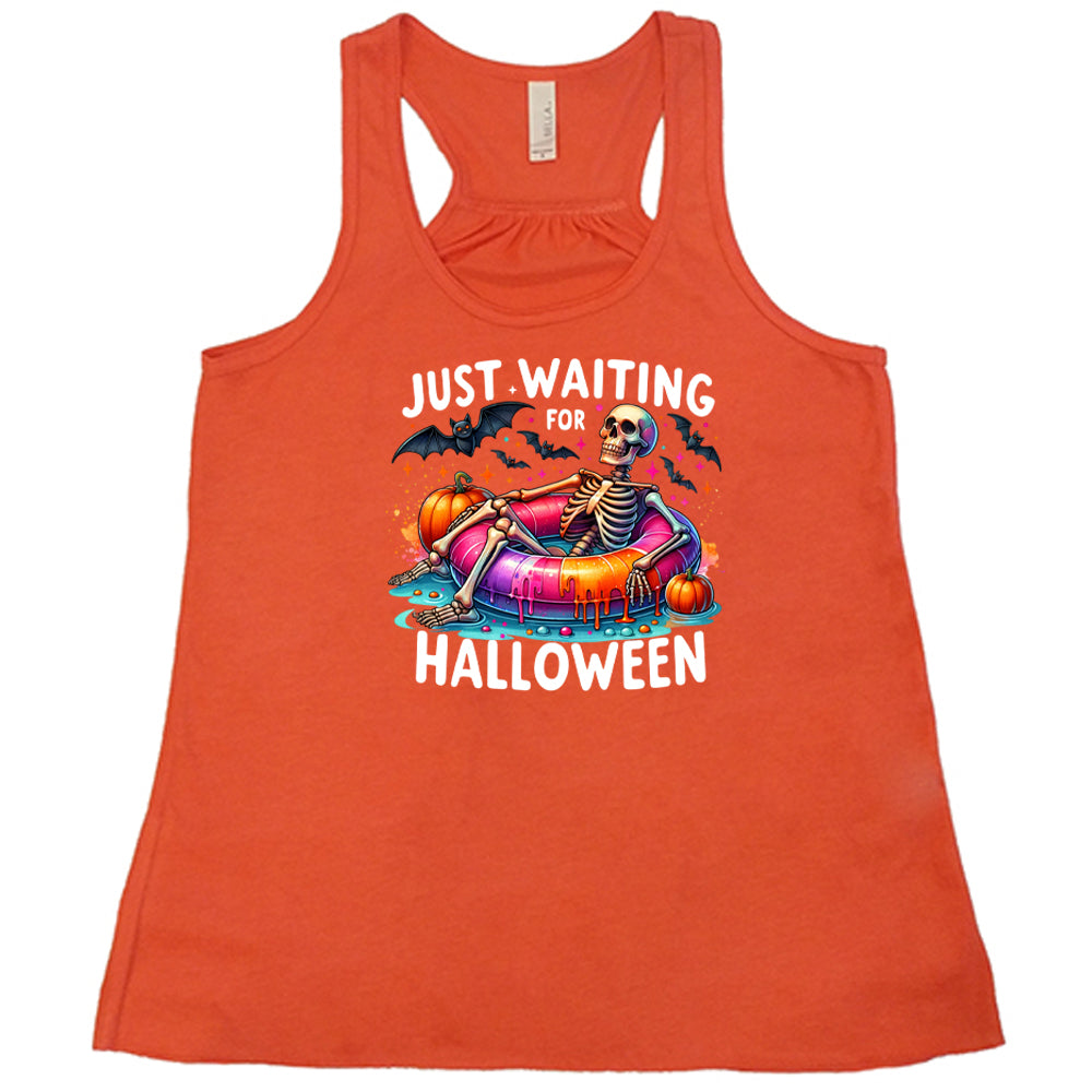 coral shirt with a colorful skeleton graphic in the center with the quote "Just Waiting For Halloween" on it