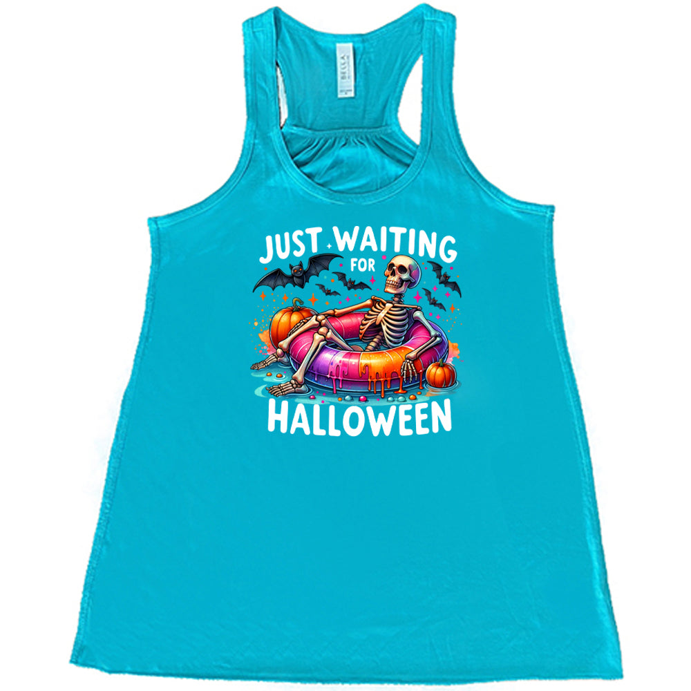 teal shirt with a colorful skeleton graphic in the center with the quote "Just Waiting For Halloween" on it