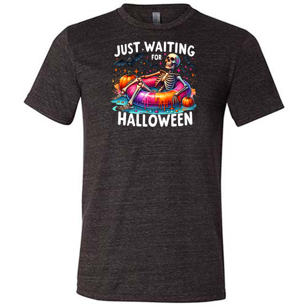 black shirt with a colorful skeleton graphic in the center with the quote "Just Waiting For Halloween" on it