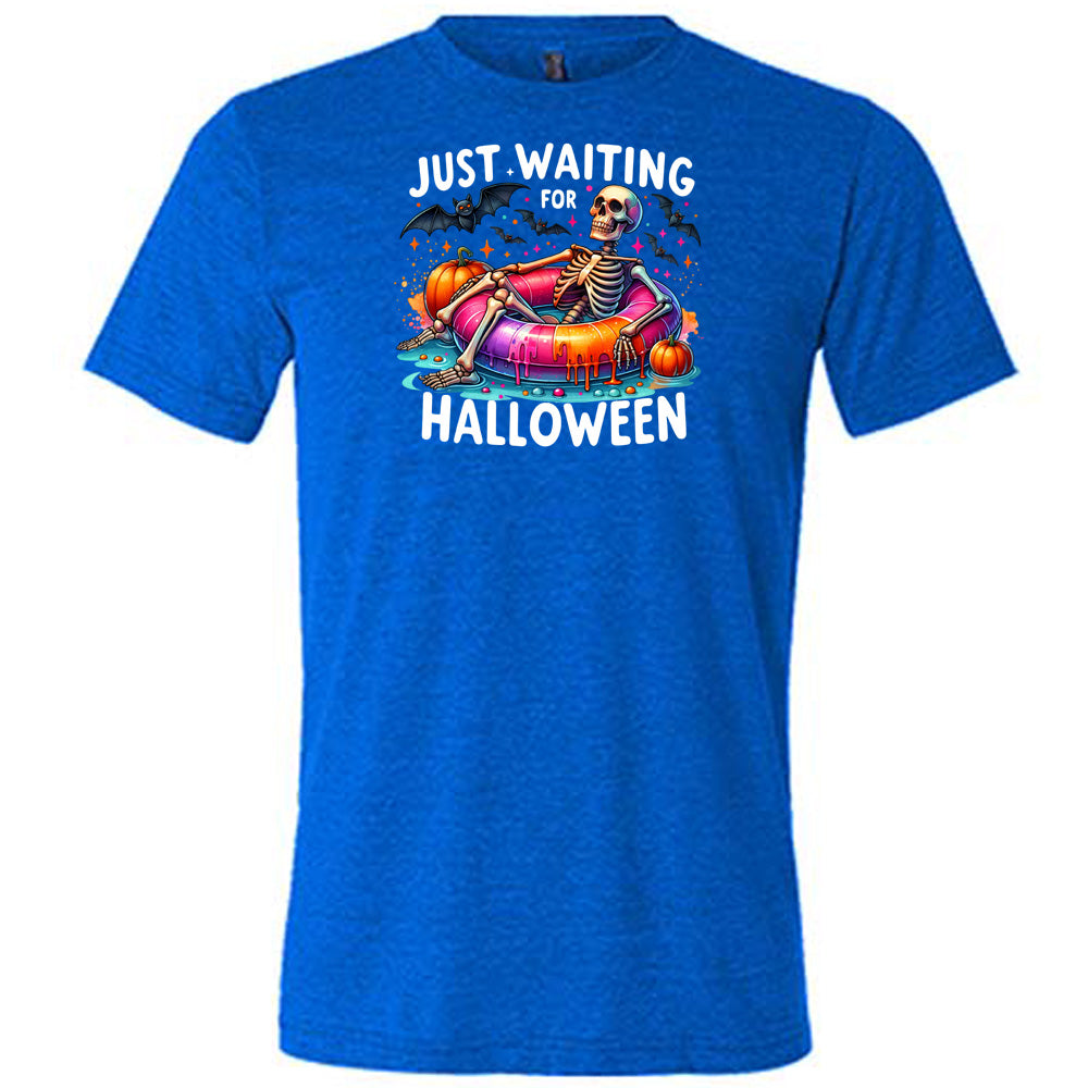 blue shirt with a colorful skeleton graphic in the center with the quote "Just Waiting For Halloween" on it