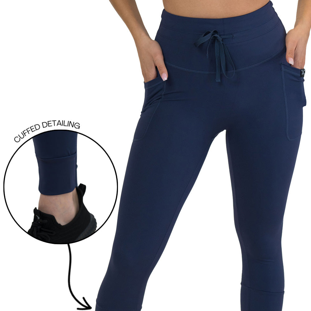 close up of the cuffed detailing on the navy blue leggings