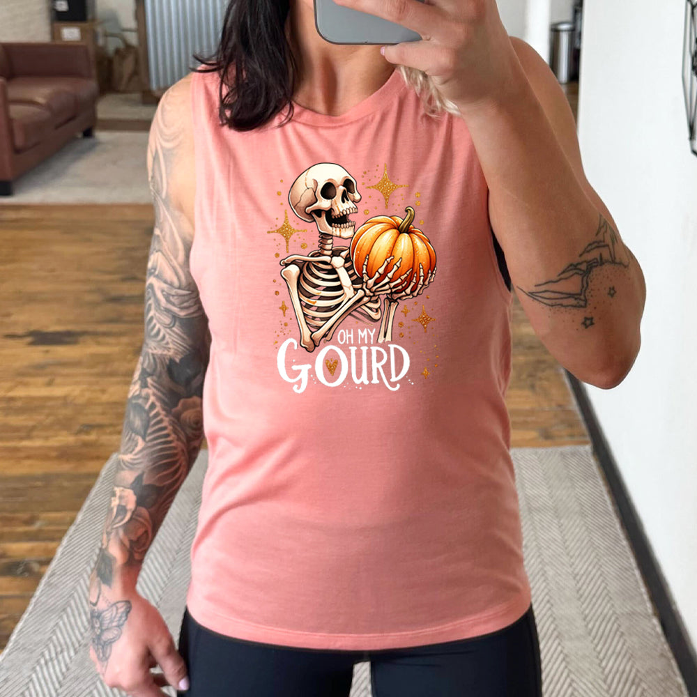 peach shirt with a skeleton holding a pumpkin graphic on it