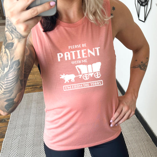 peach muscle tank with the saying "please be patient with me I'm from the 1900's"