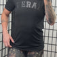 model wearing the black shirt with the word "feral" in the middle of it