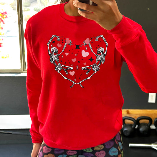 red crewneck with a skeleton heart graphic on it